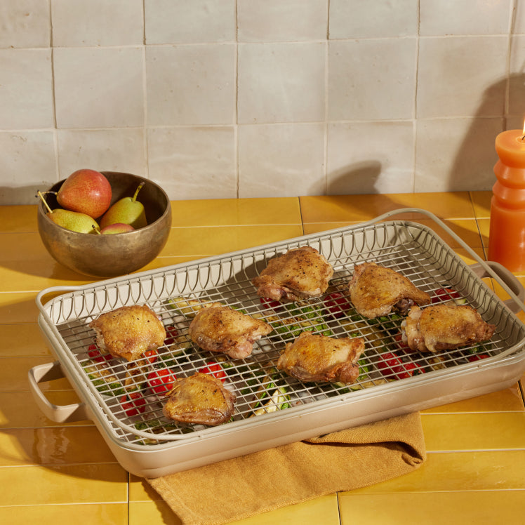 beige ultimate bakeware set with veggies and chicken on oven rack