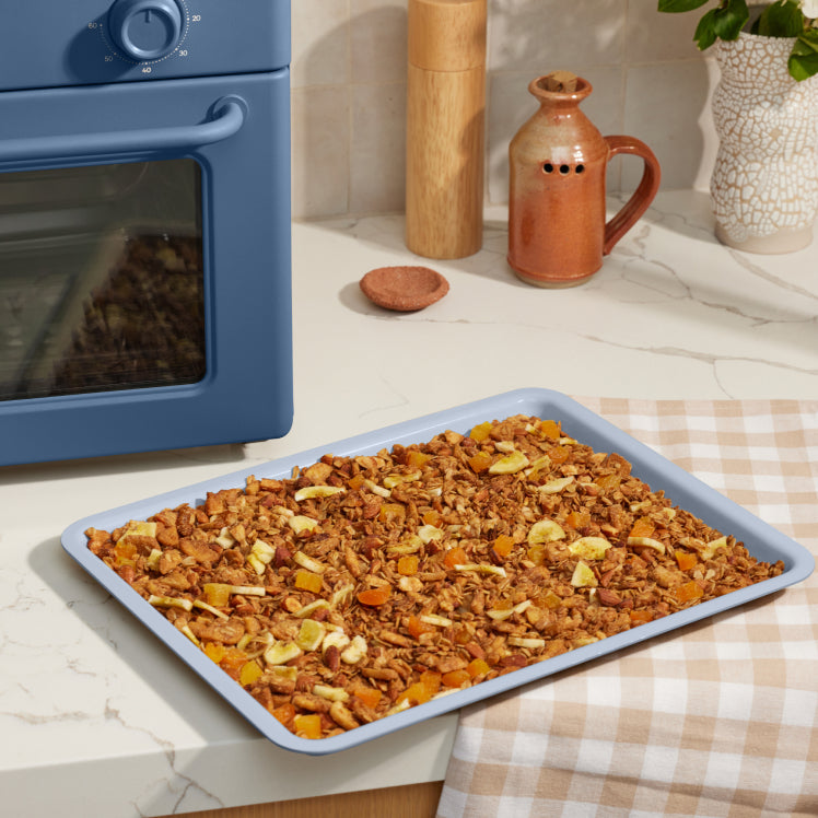 blue large wonder oven tray on counter with baked granola