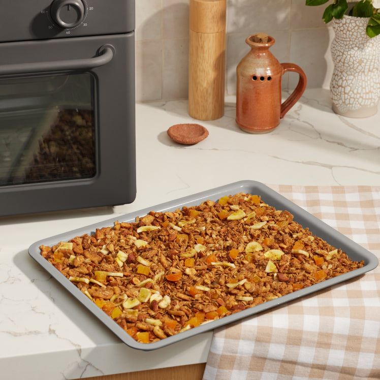 black large wonder oven tray on counter with baked granola