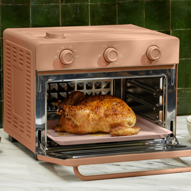 baking chicken in pink large wonder oven on counter