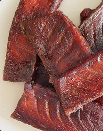 Dried salmon jerky on a white plate