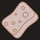 A simple illustration of a sanitary pad with circular designs on its surface, displayed on a black background.