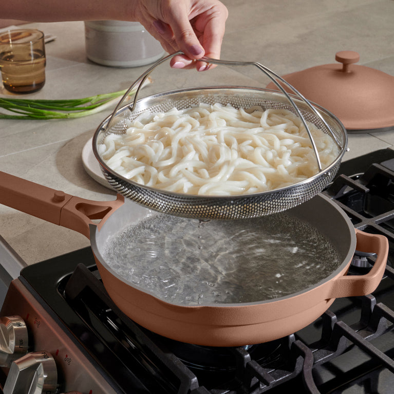 pink-always-pan-on-stovetop-with-noodles