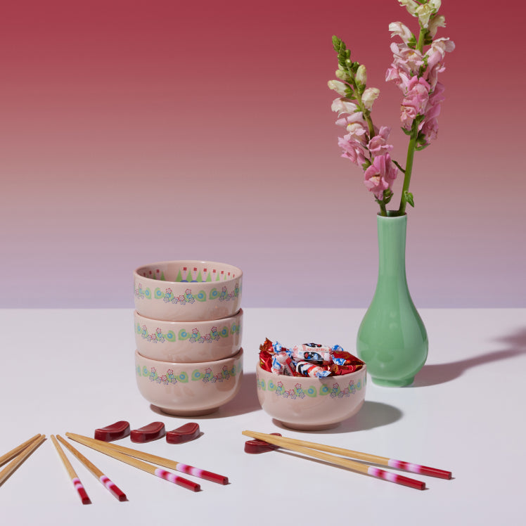 pink rice bowl set of 4 with chopsticks on table