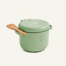 A green Rice Cooker featuring a digital display and accompanied by a wooden spatula on its side, displayed against a plain background.