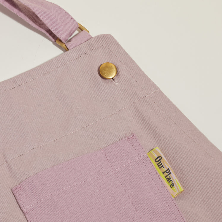 Close up of the top pocket on a purple Home Cook Apron