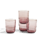 Four short, rounded, translucent pink drinking glasses are grouped together on a white surface with a plain background.