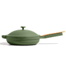 An olive green cast iron skillet with a matching lid and a light wood handle, shown on a clean white background.
