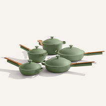 The Cookware Set+ includes four green nonstick ceramic pieces with matching lids and wooden handles, showcased on a light background.