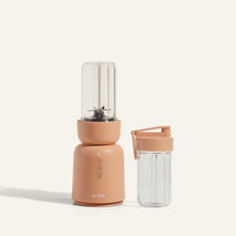 Portable blender with a clear container on a white background