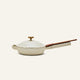 The Ceramic Nonstick Always Pan 20 cm, shown in a cream color with a matching lid and a wooden handle, is displayed against a plain, light background.