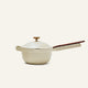 A small, round, light-colored Ceramic Nonstick Perfect Pot 2.5 L with a lid and a wooden handle is shown against a plain, light background.
